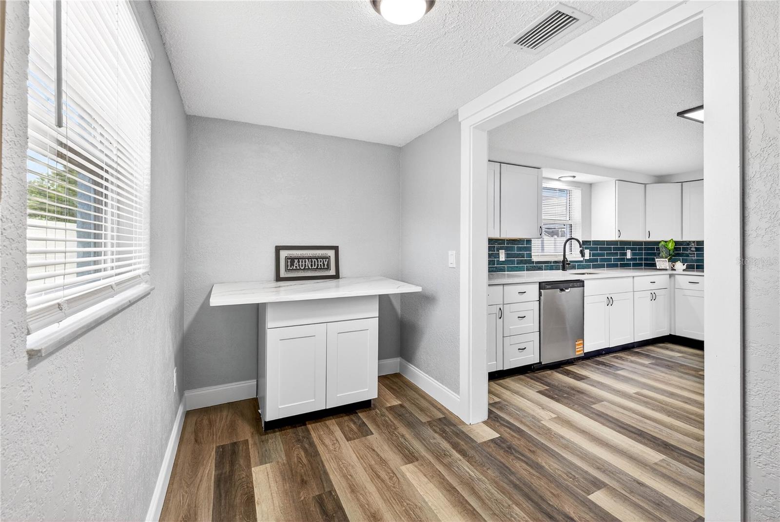 AREA OFF THE KITCHEN FOR FOLDING CLOTHES OR COFFEE BAR; EXTRA STORAGE