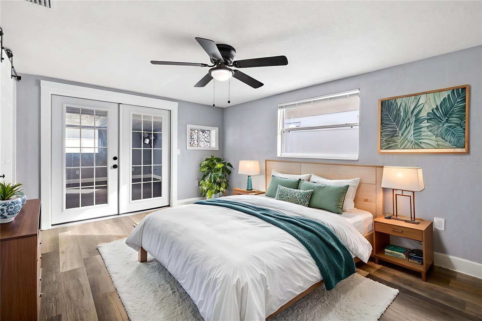 MASTER BEDROOM WITH ACCESS TO THE POOL THROUGH FRENCH DOORS; *VIRTUALLY STAGED*