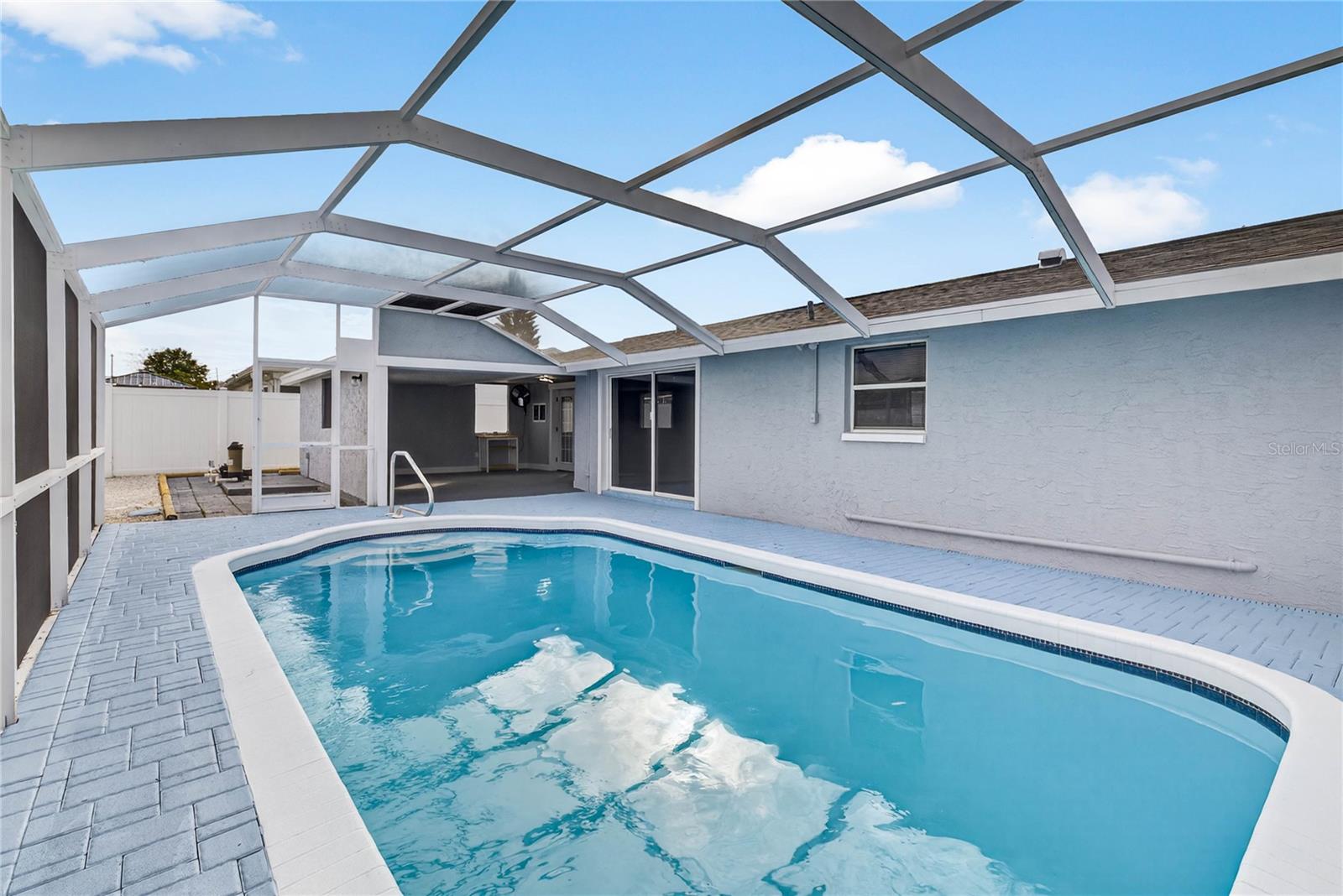 BEAUTIFUL POOL AREA WITH SCREEN CAGE AND COVERED SITTING AREA