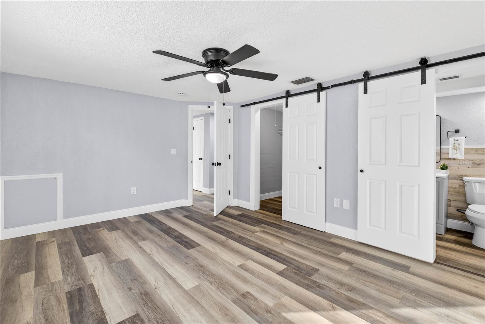 MASTER BEDROOM: BARN DOORS INTO WALK-IN CLOSET AND ENSUITE