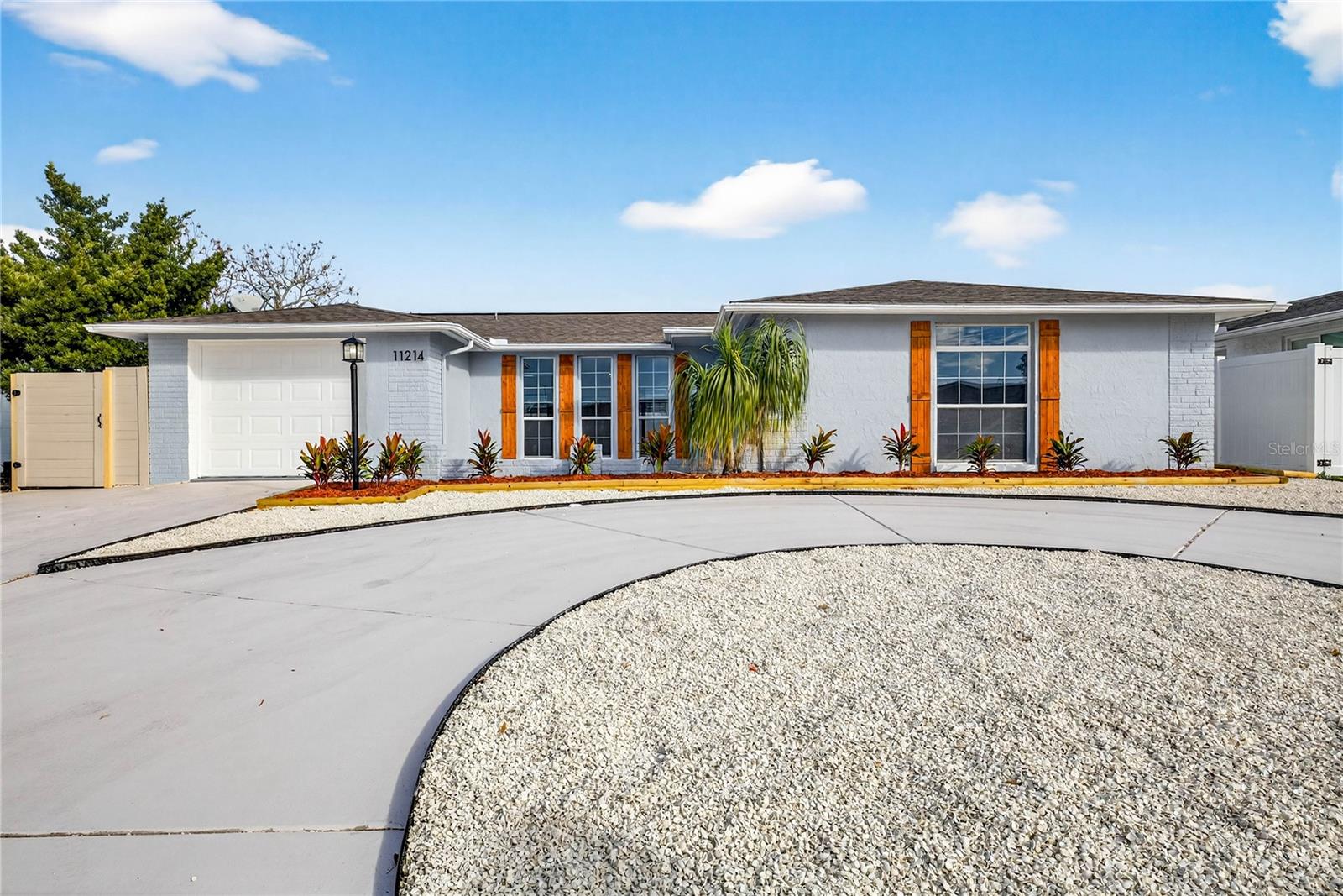 MAINTENANCE FREE FRONT YARD WITH CIRCULAR DRIVEWAY AND EXTRA PARKING