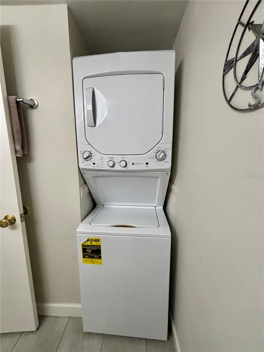 Stackable washer dryer unit in lower floor bathroom