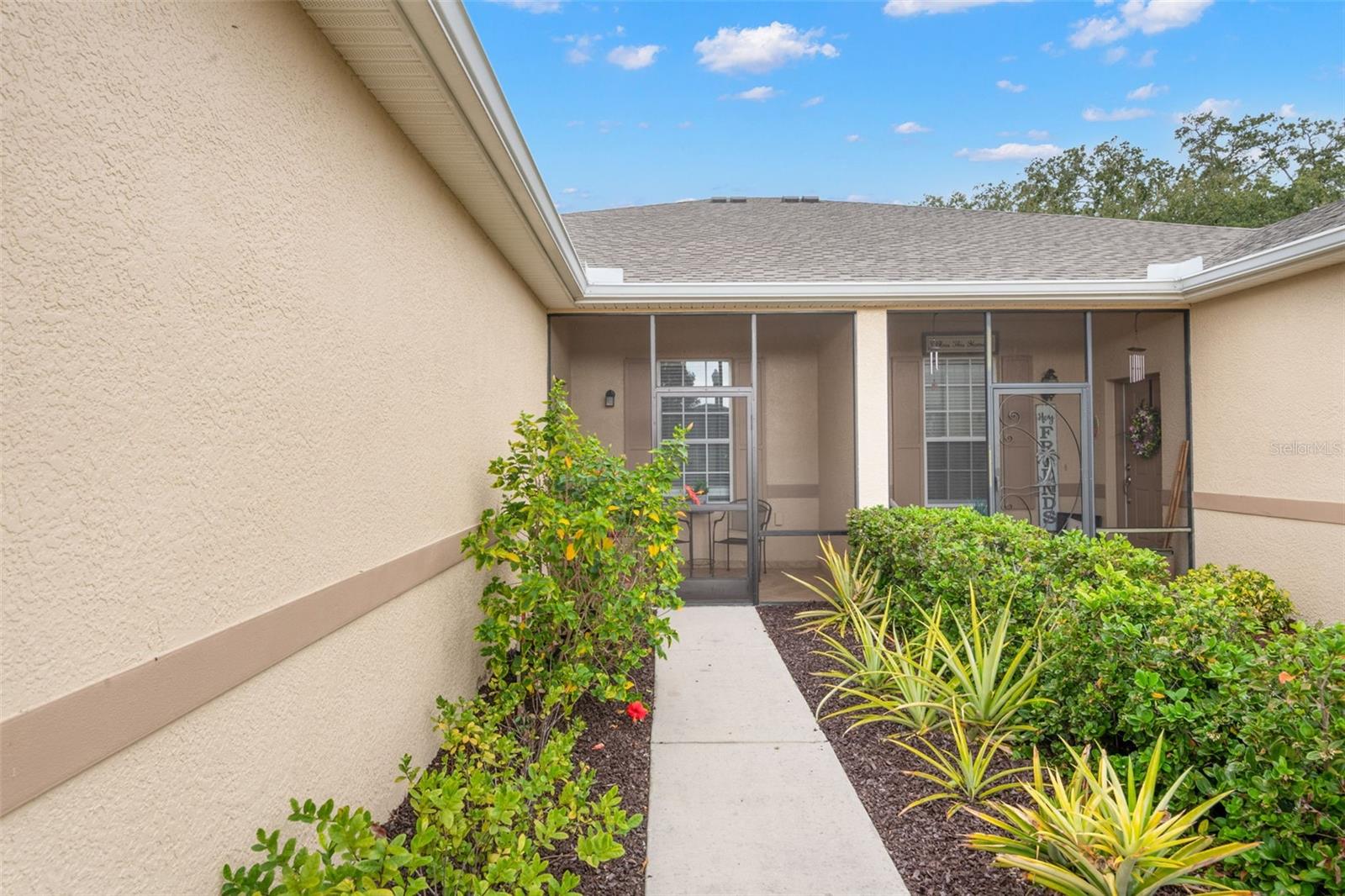 Front walk with lush landscape including pineapple