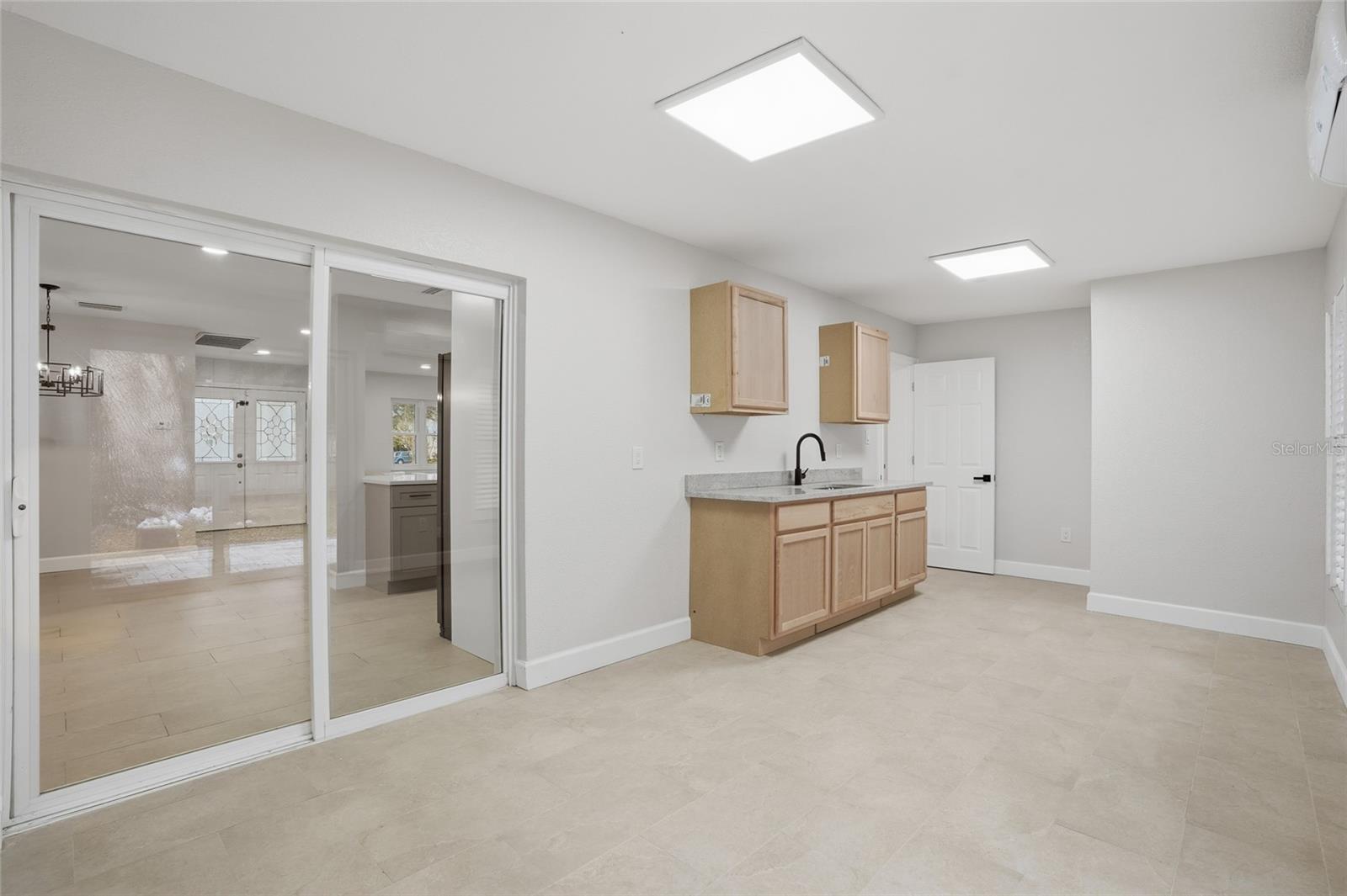 Enclosed Sunroom with Wet Bar and Cabinetry