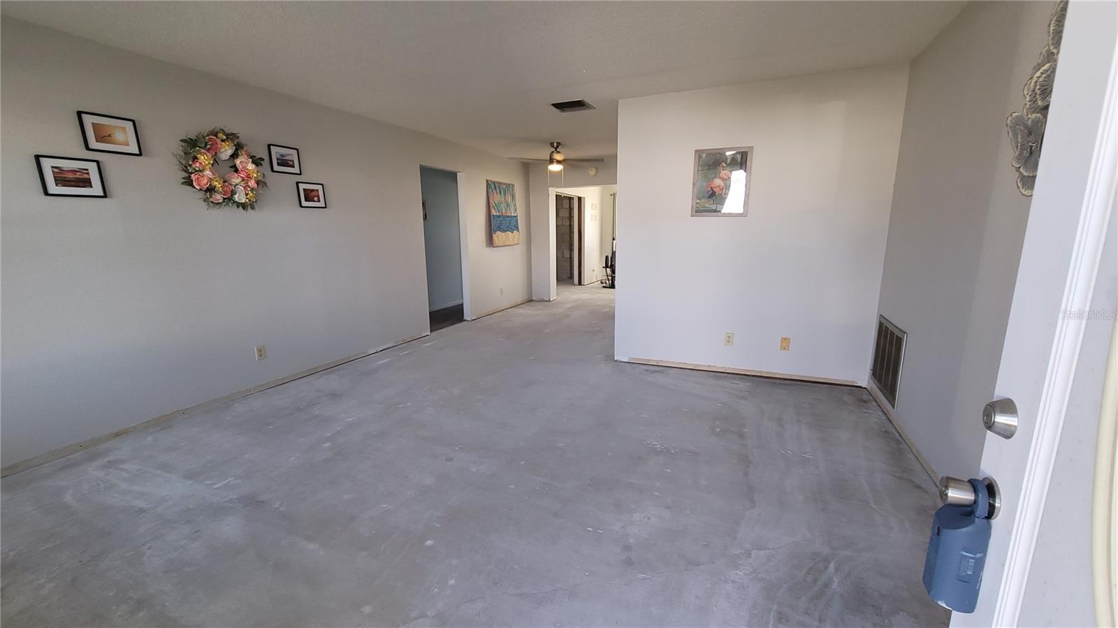 The 50+ year old carpet was removed and not replaced allowing the buyer to choose how to finish it off. This home was not affected by the hurricanes in 2024.