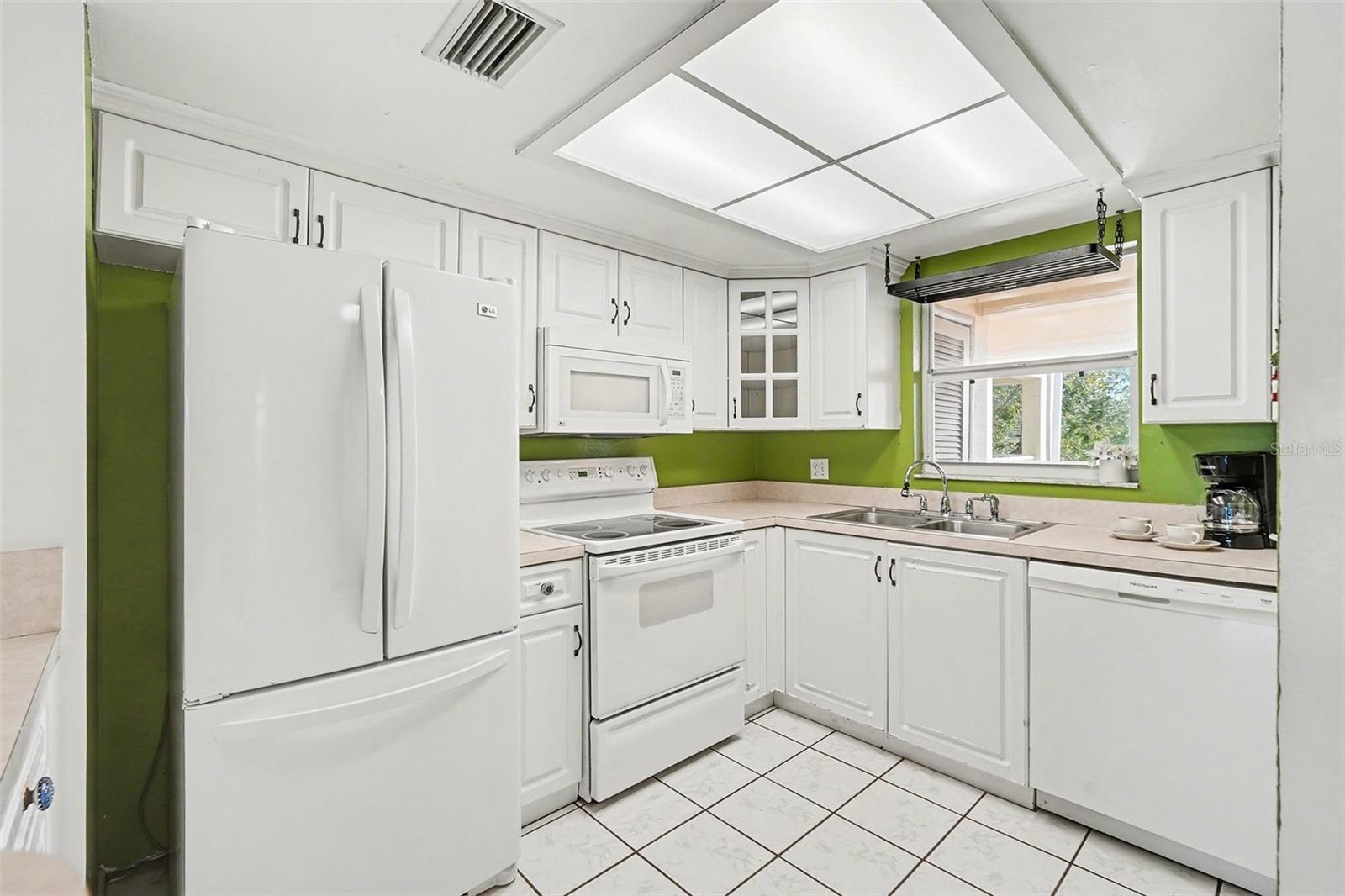 Crisp and clean kitchen at the front of the condo.