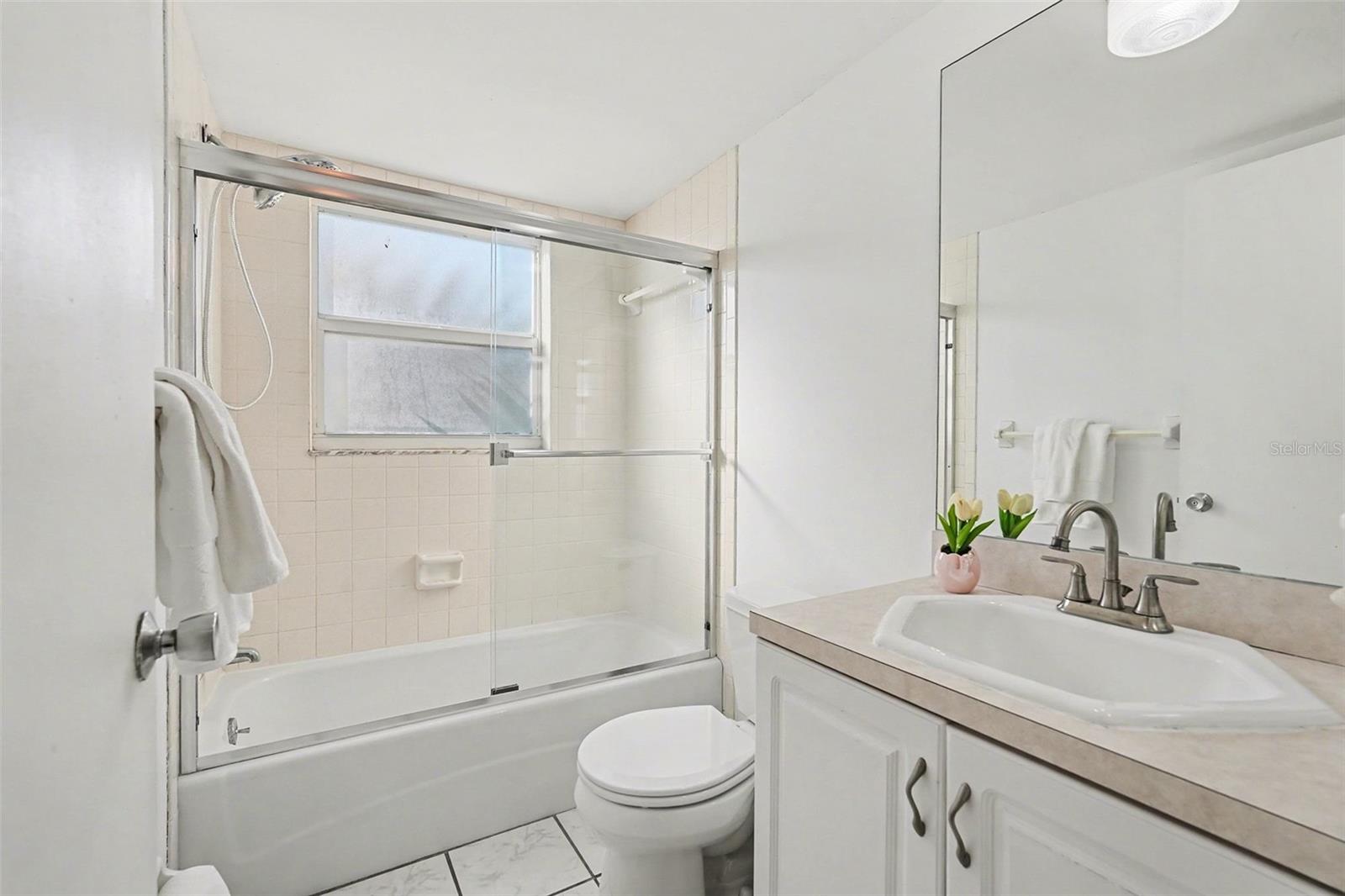 Hall bath located just outside bedroom 1 for guests.