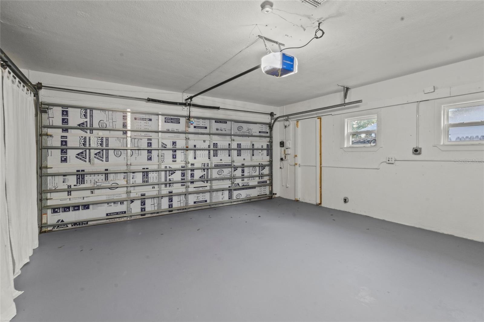 Two-Car Garage – Oversized two-car garage with clean epoxy-coated floor and automatic opener.