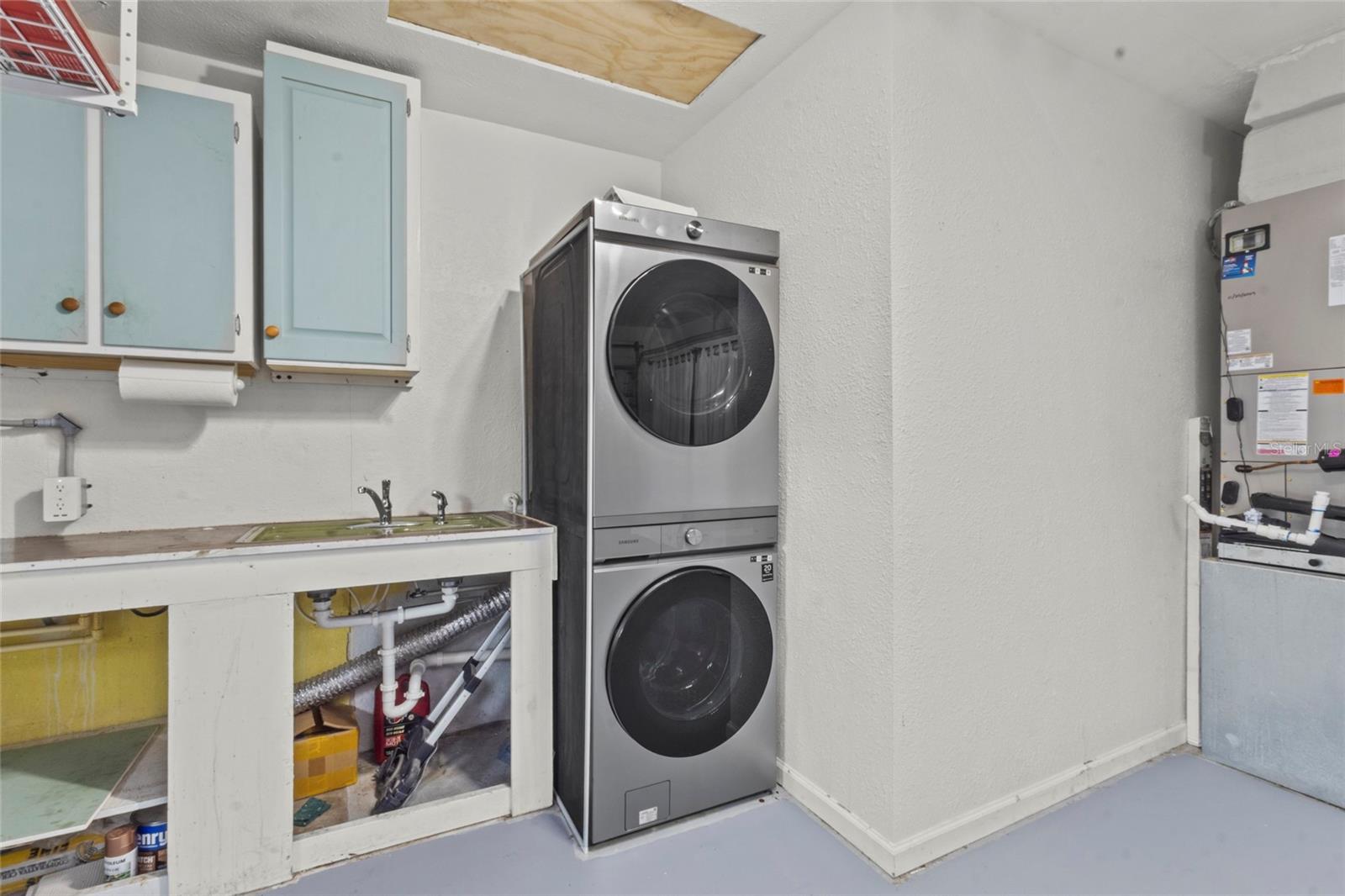 Laundry Area – Dedicated laundry space with washer/dryer, utility sink, and storage cabinetry.