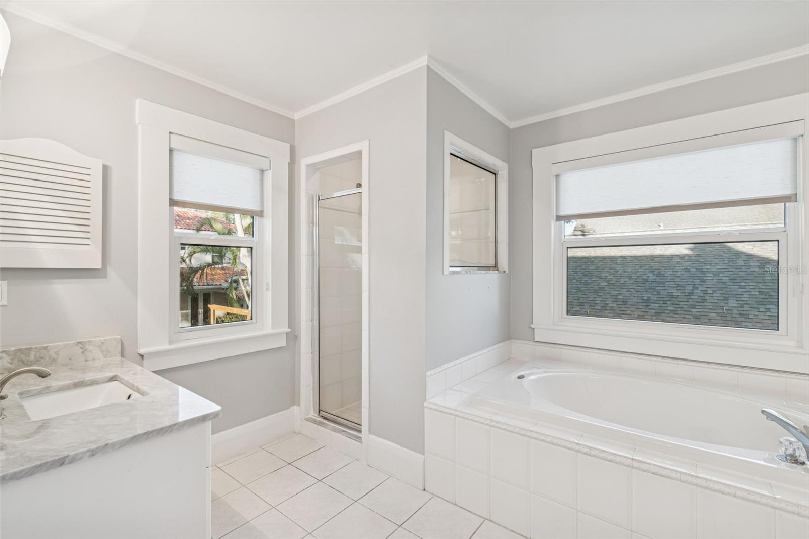 Primary bathroom with separate tub and shower