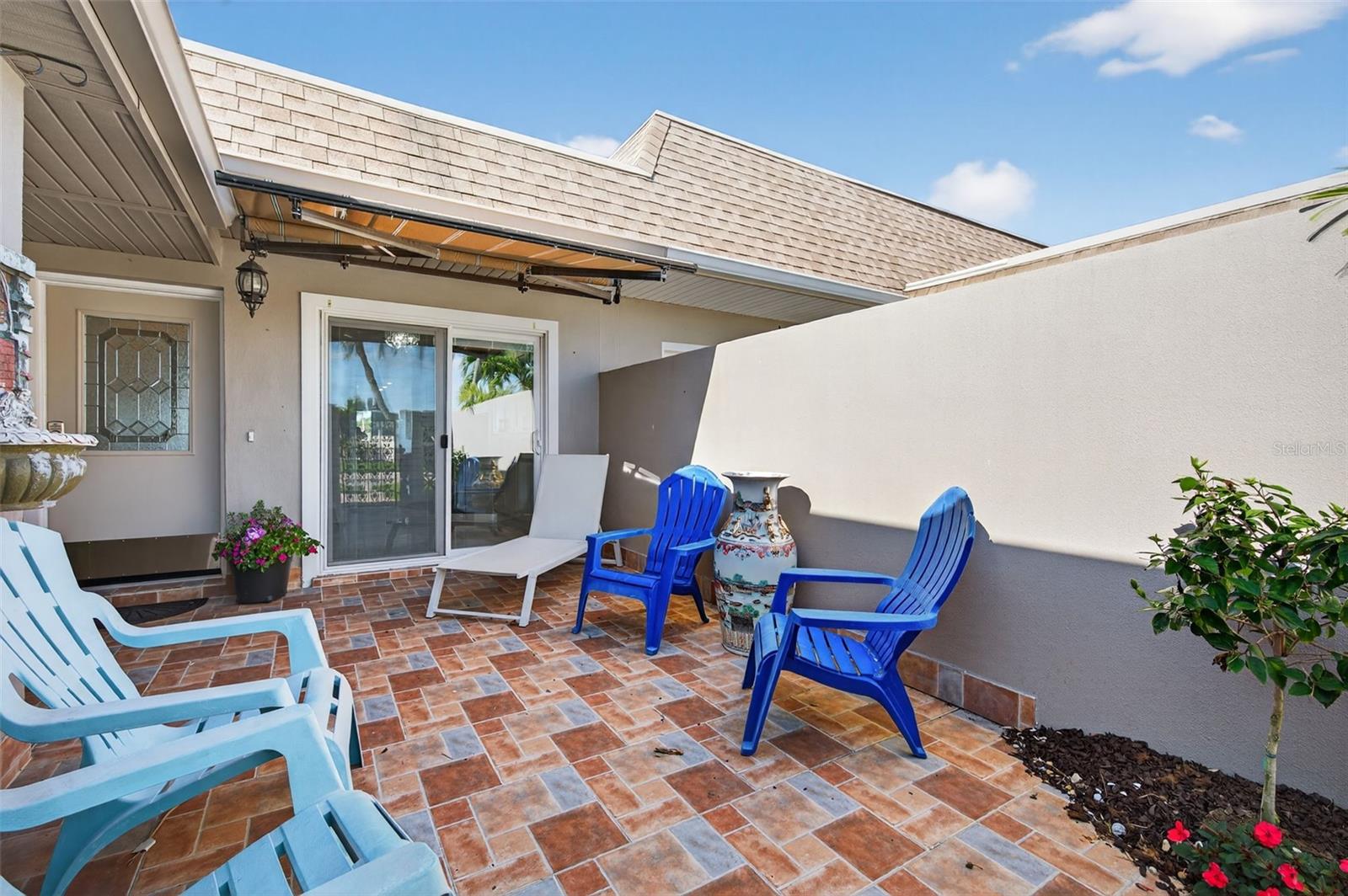 Front door is adjacent to sliding doors to Kitchen