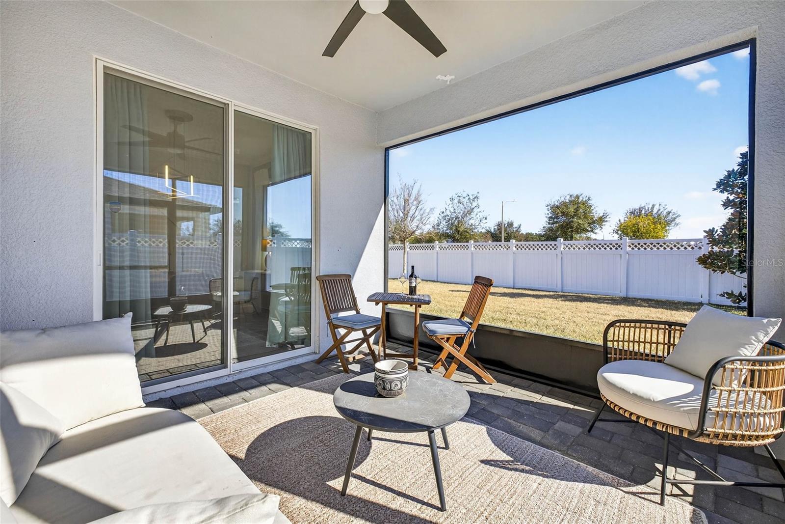 Wait! We arent done - - the backyard has screened lanai and overhead fan for outdoor dining and relaxation.