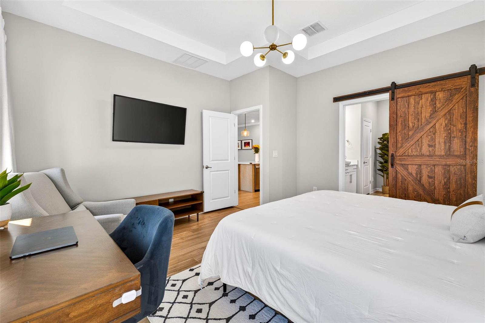 Spacious, bright, tray ceiling + overhead lighting.  Barn door upgrade to the ensuite bath.
