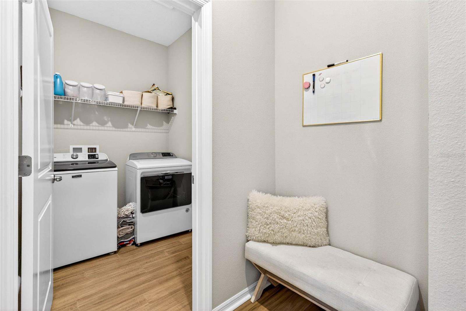Laundry room adjacent to the entryway catch all area.