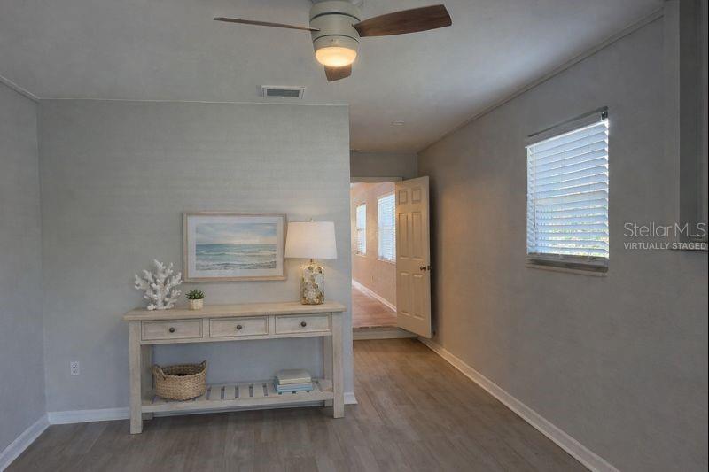 Primary bedroom with direct access to a private en-suite bathroom. (The photo has been virtually staged to illustrate the potential use of the space).