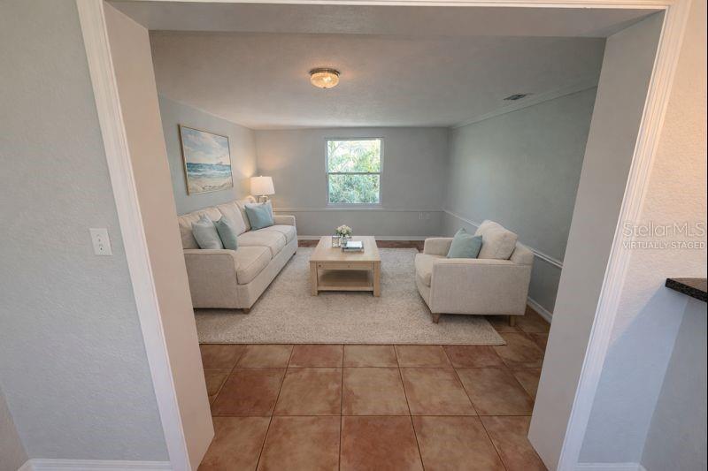 Flexible bonus room that can serve as a den, sitting room, or whatever you need!  (Photo has been virtually staged to illustrate potential use of space).