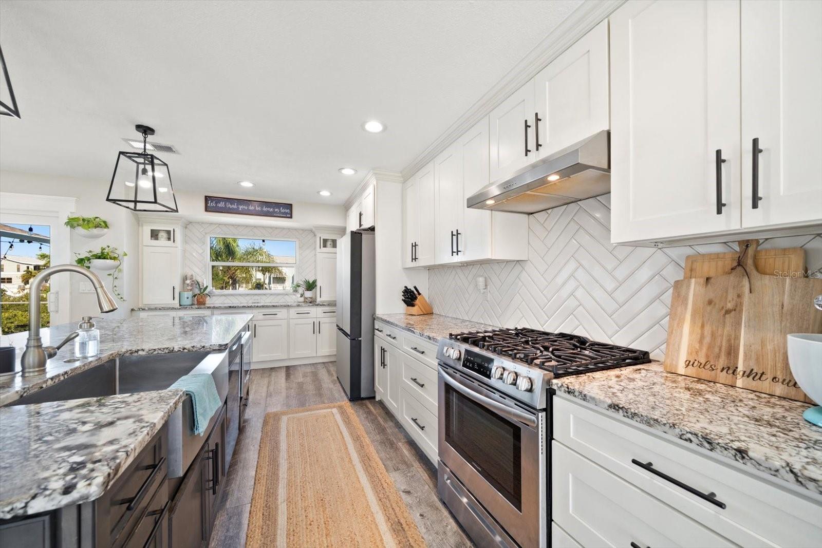 Timeless design with granite counters, gas stove and plenty of cabinetry