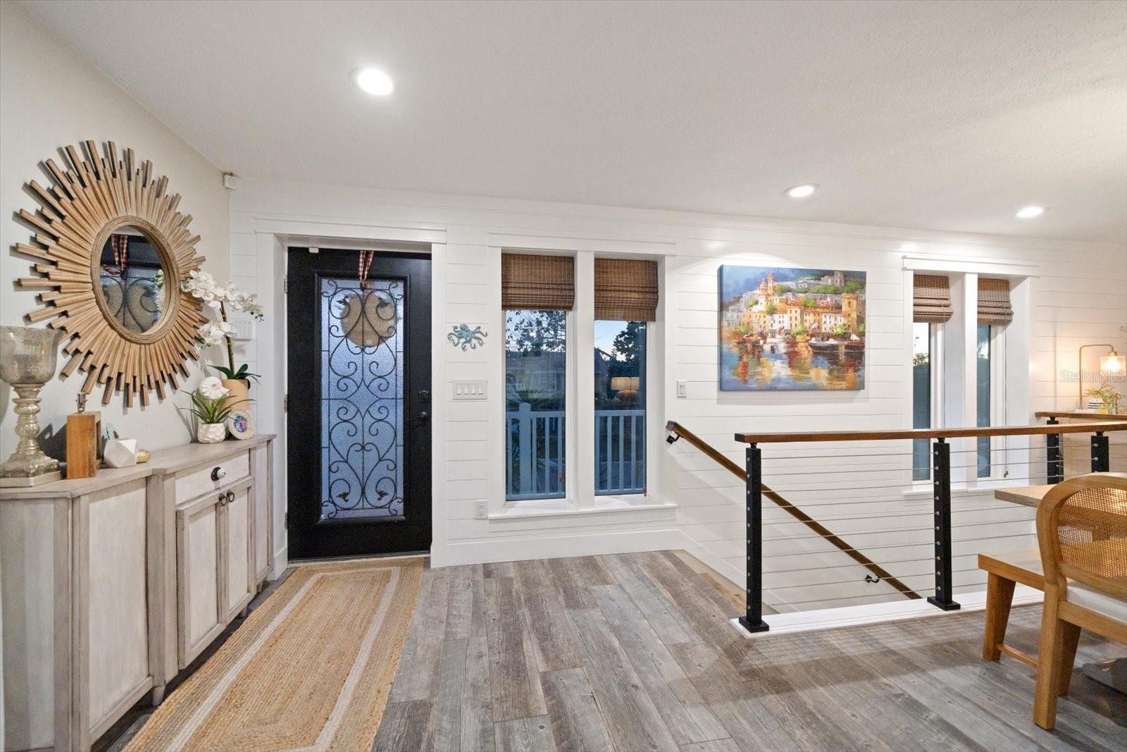 Custom ship-lap walls and warm wood style tiles to welcome you home!