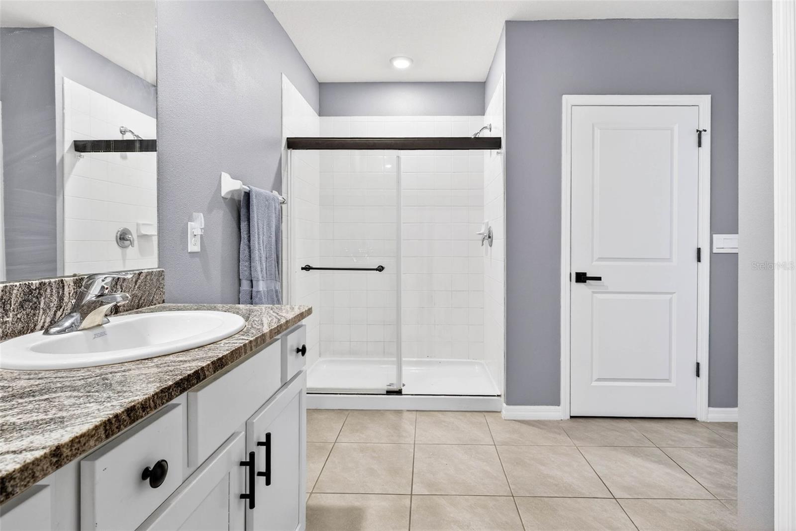 Primary has dual sinks, large linen closet, and walk in shower.