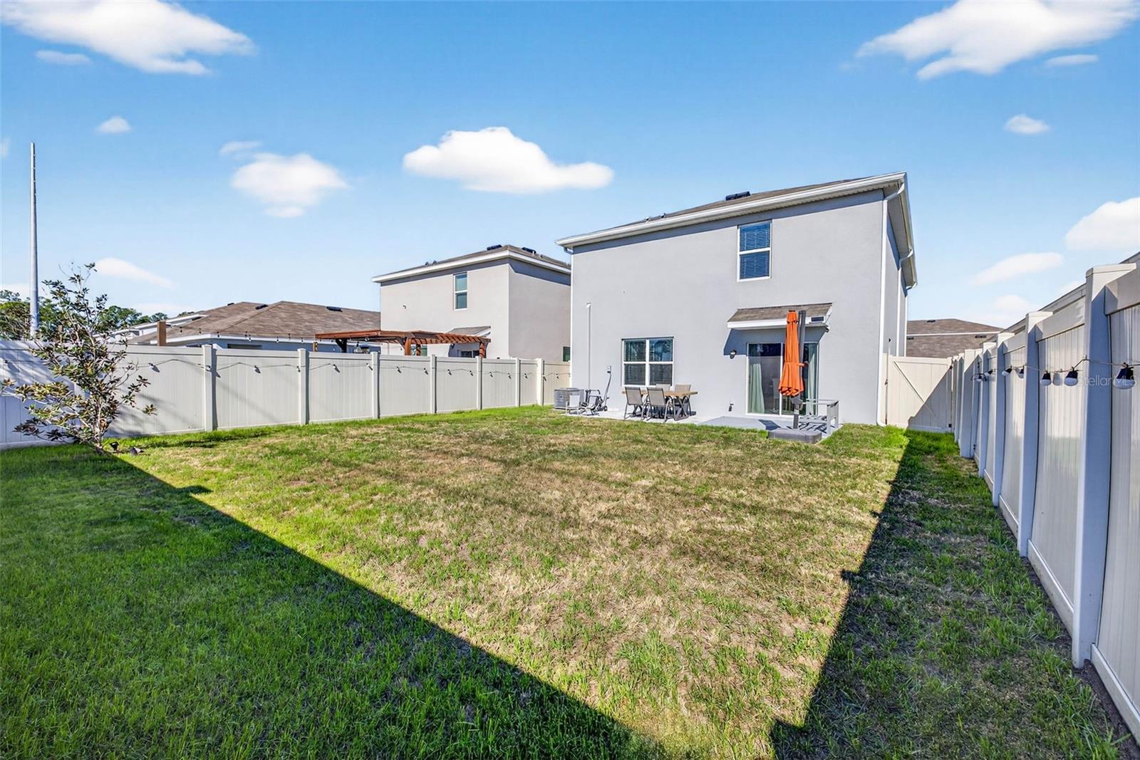 Huge, fully fenced back yard with outdoor patio.