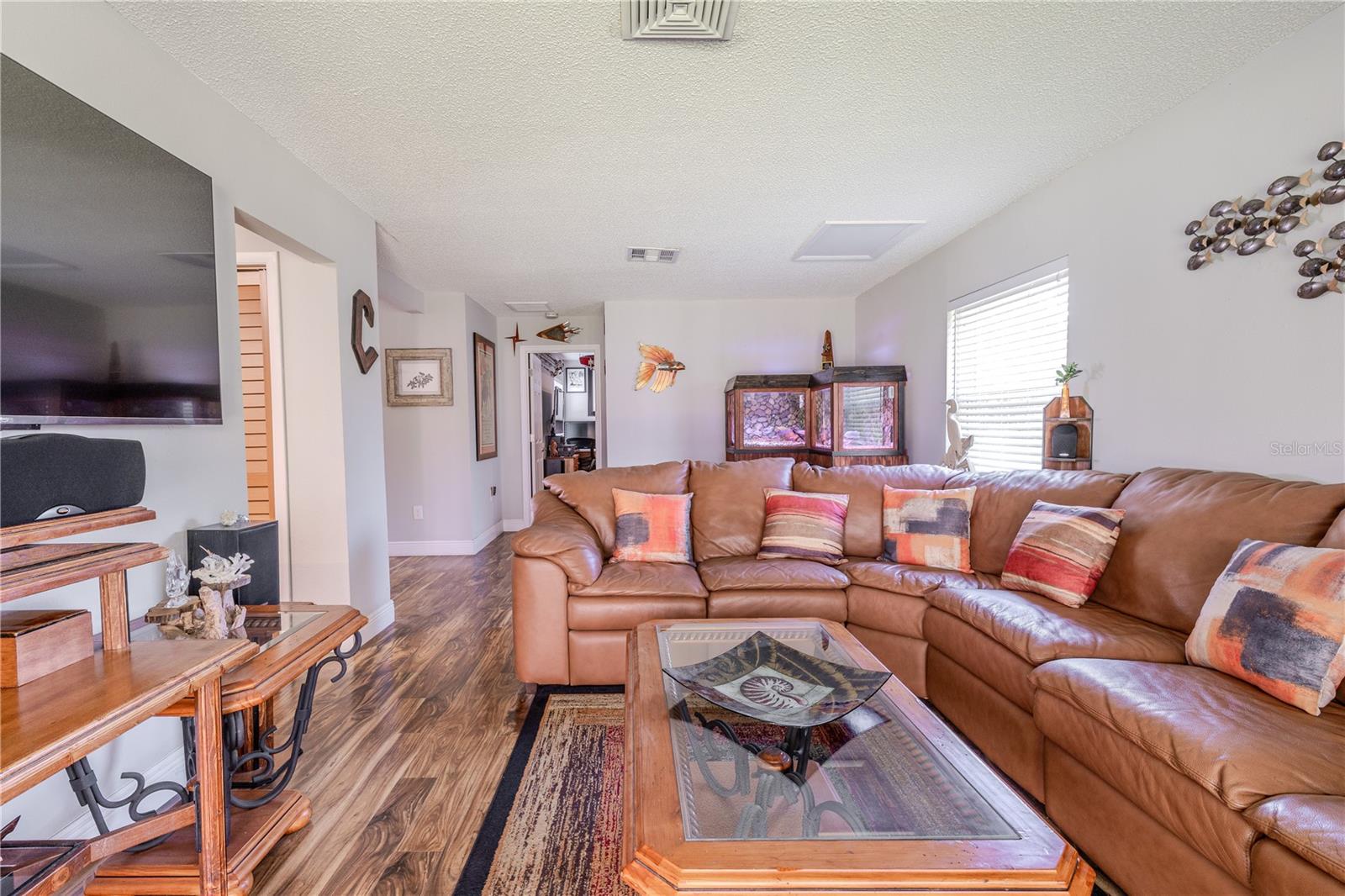 Open family room with wide sightlines, durable flooring, and a layout that connects seamlessly to the rest of the home.