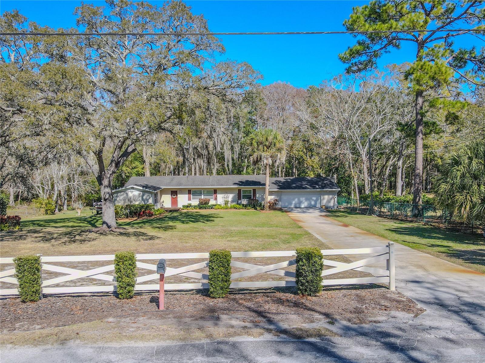 Street-level view emphasizing the home’s wide frontage and established neighborhood setting.