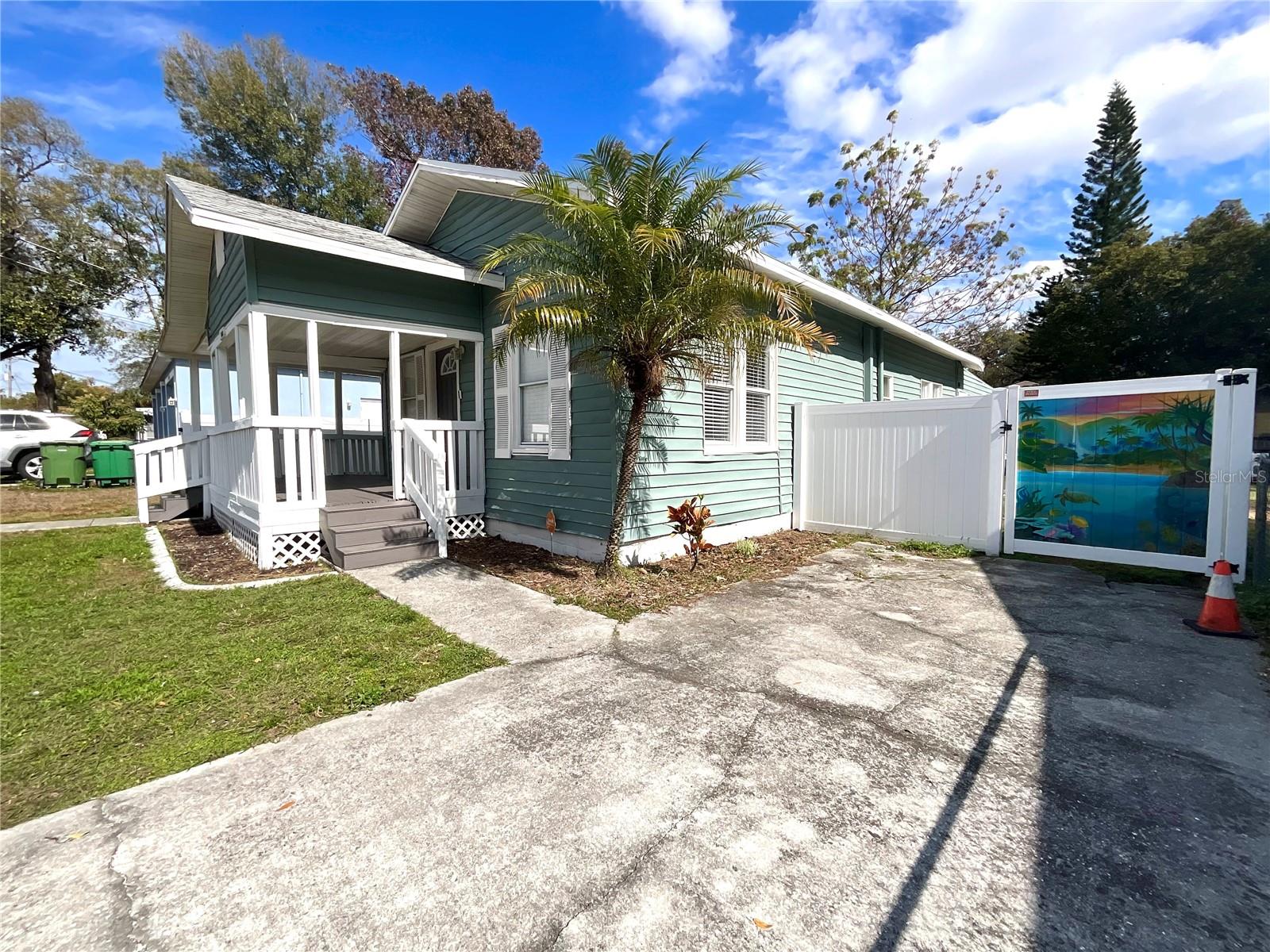 Side view, parking pad and private fencing/gate.