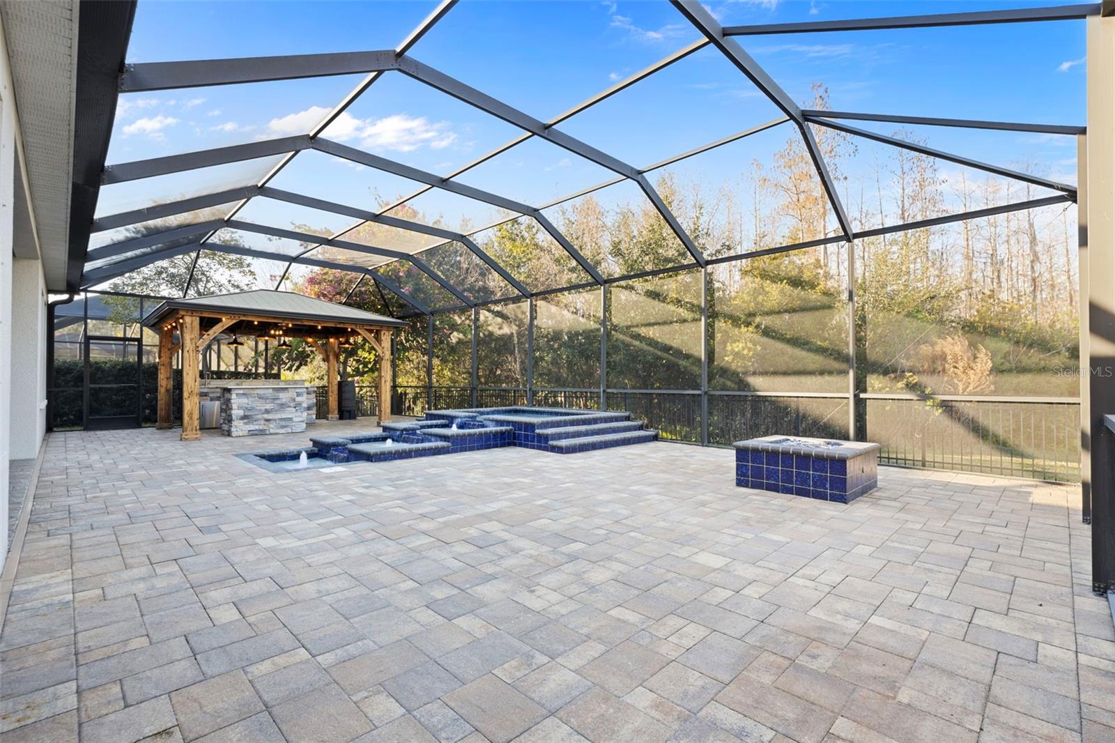 Expansive screened-in lanai and paver patio