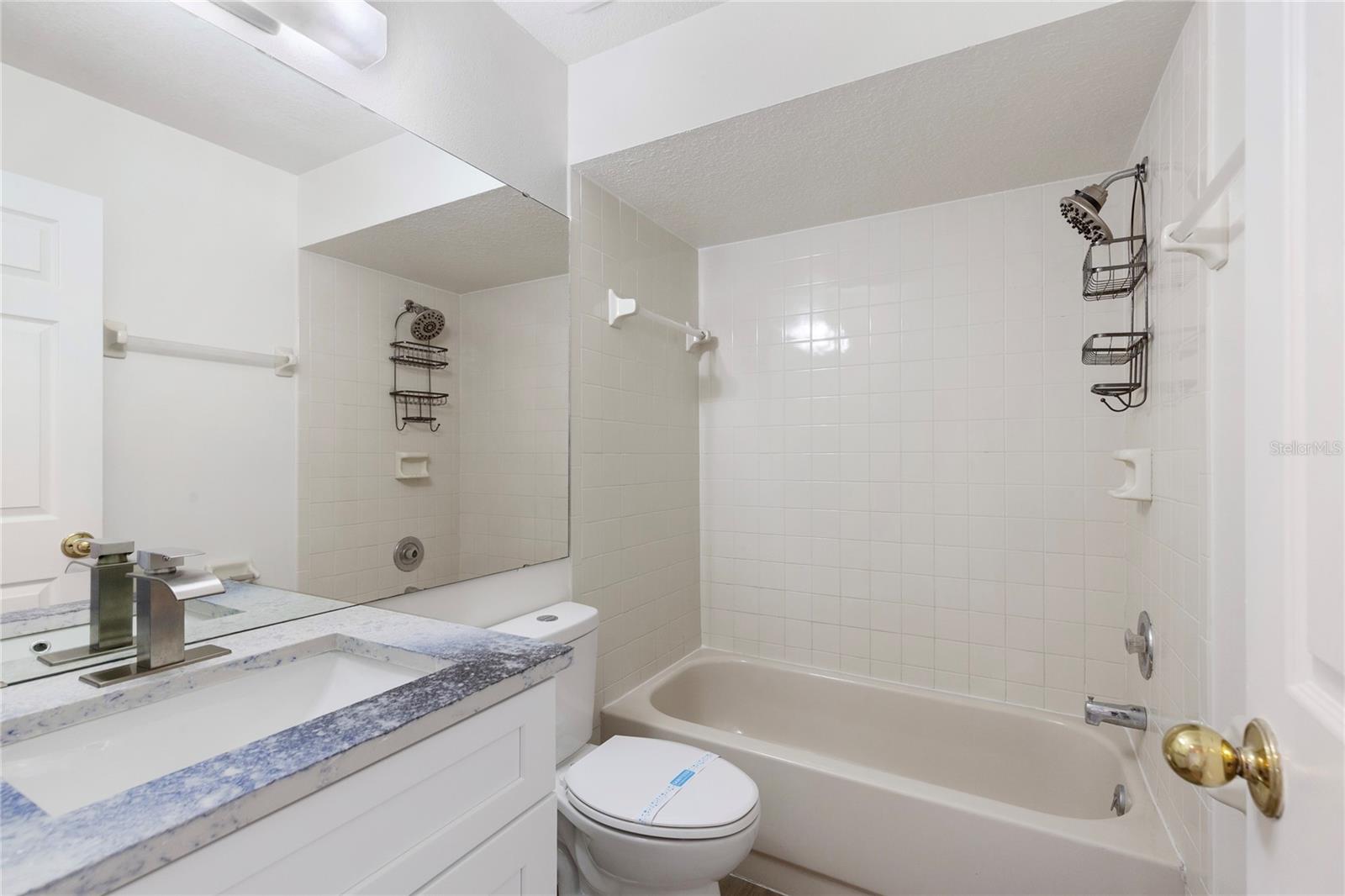 Guest bath with new uniwue countertops, faucets and fixtures
