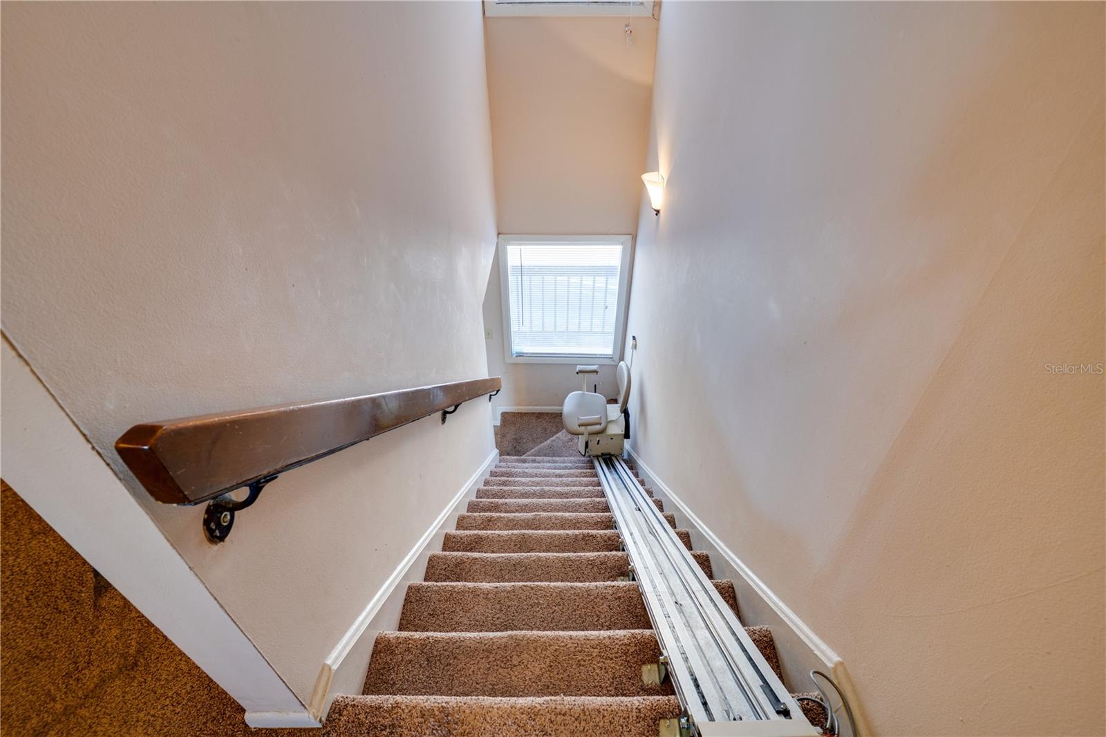 Stairs with chair lift going to Primary & Second Bedrooms