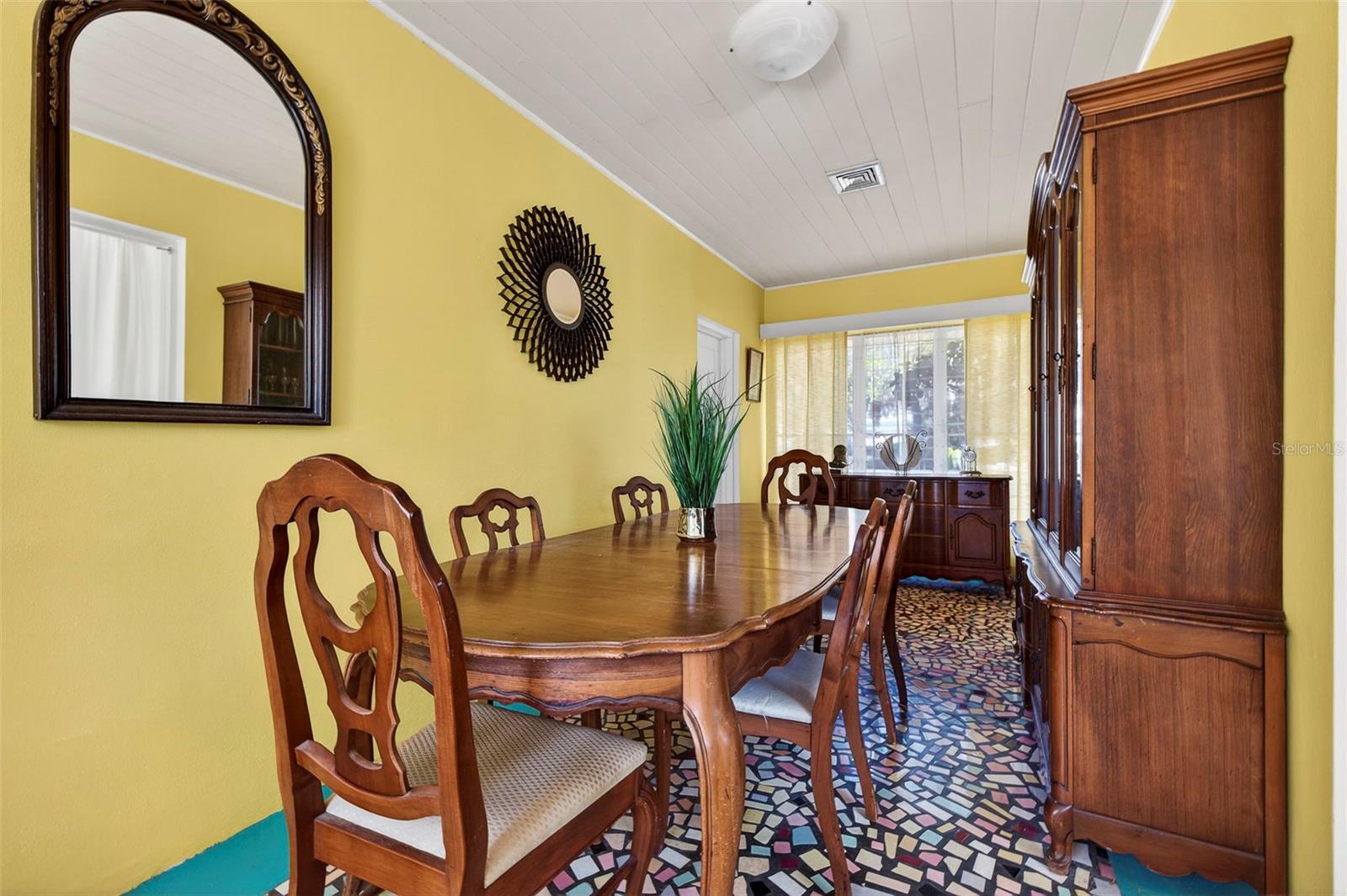 This room showcases an original mosaic floor that creates a beautiful focal point rich in craftsmanship and charm.