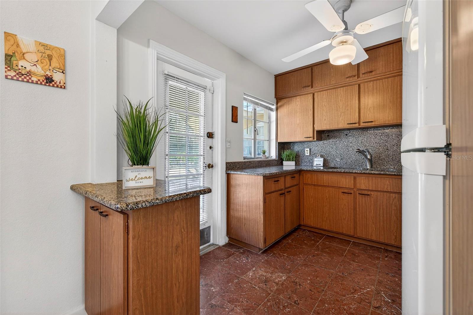 The kitchen features marble flooring and new granite countertops