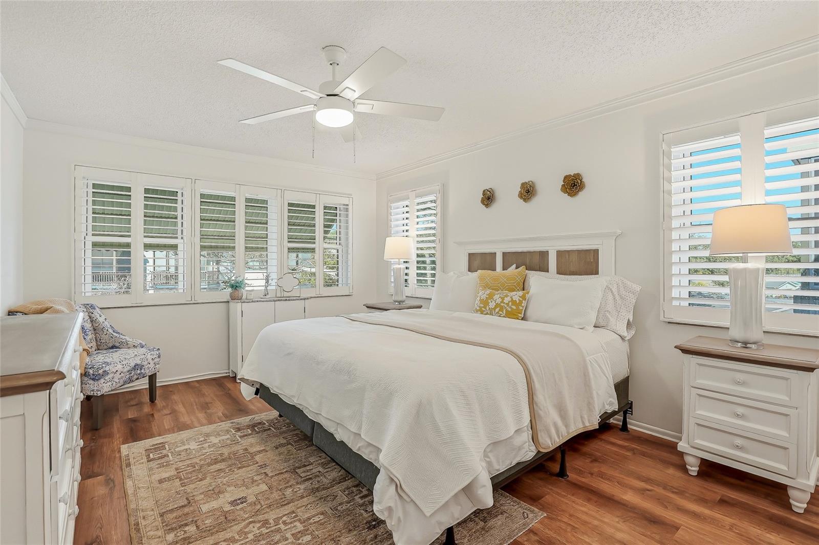 The primary bedroom features two walls of windows  and added privacy of no abutting neighbor to this room.