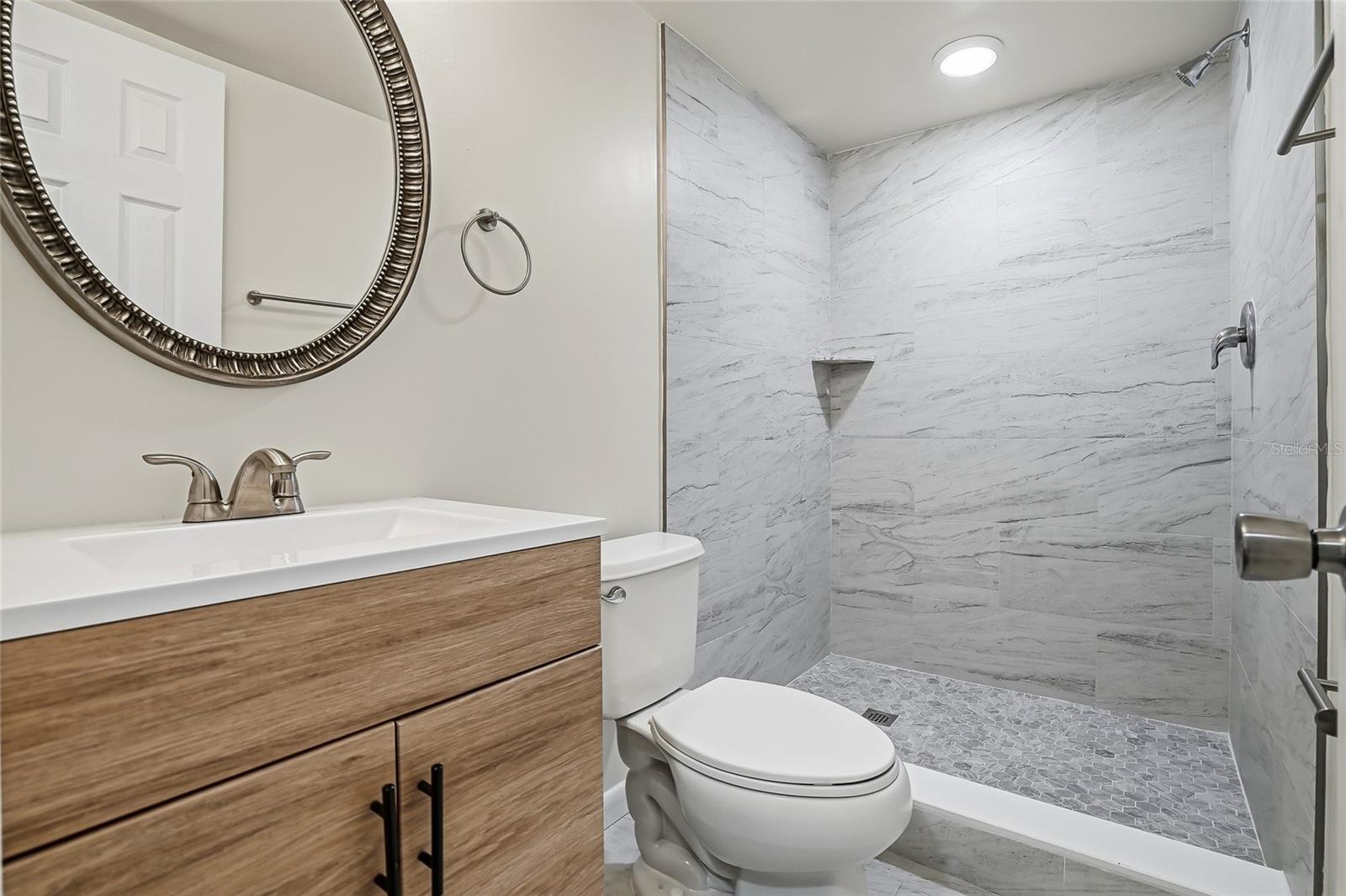 Second full bathroom with step in shower.