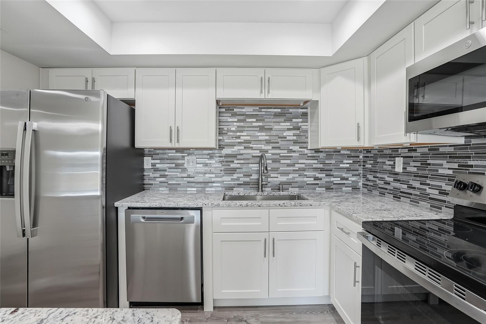 Modern kitchen equipped with brand new stainless steel appliances