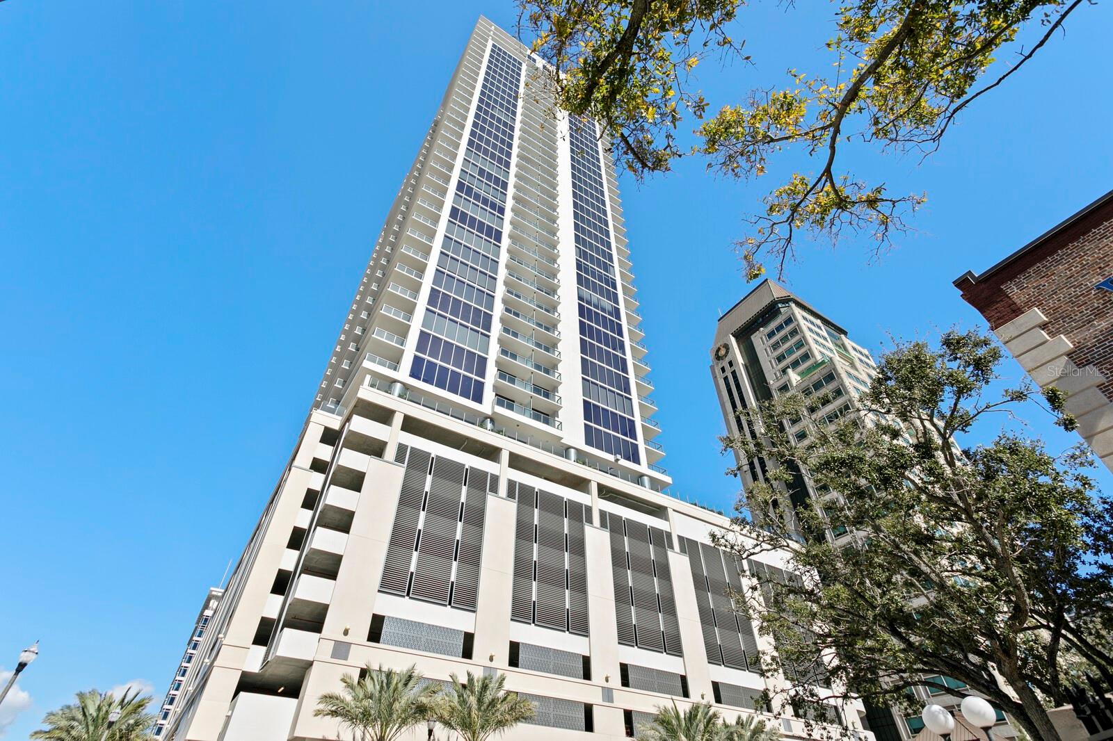 Living Room with sliders to balcony with views of the pier, water and city.