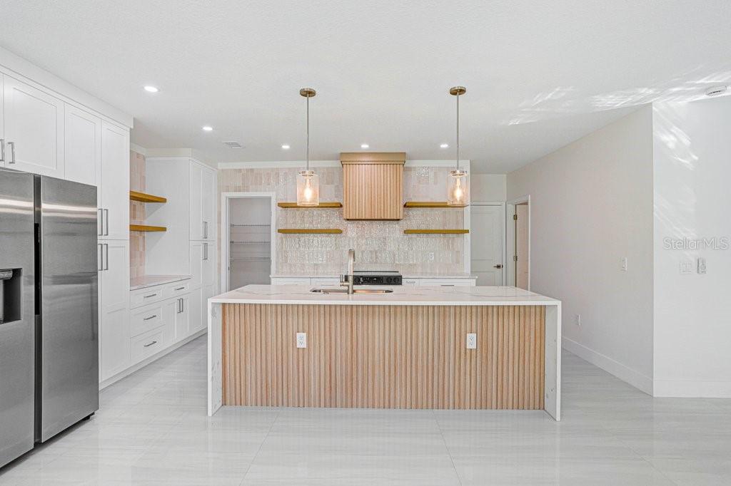 Beautifully Updated Kitchen with Waterfall Quartz Countertops