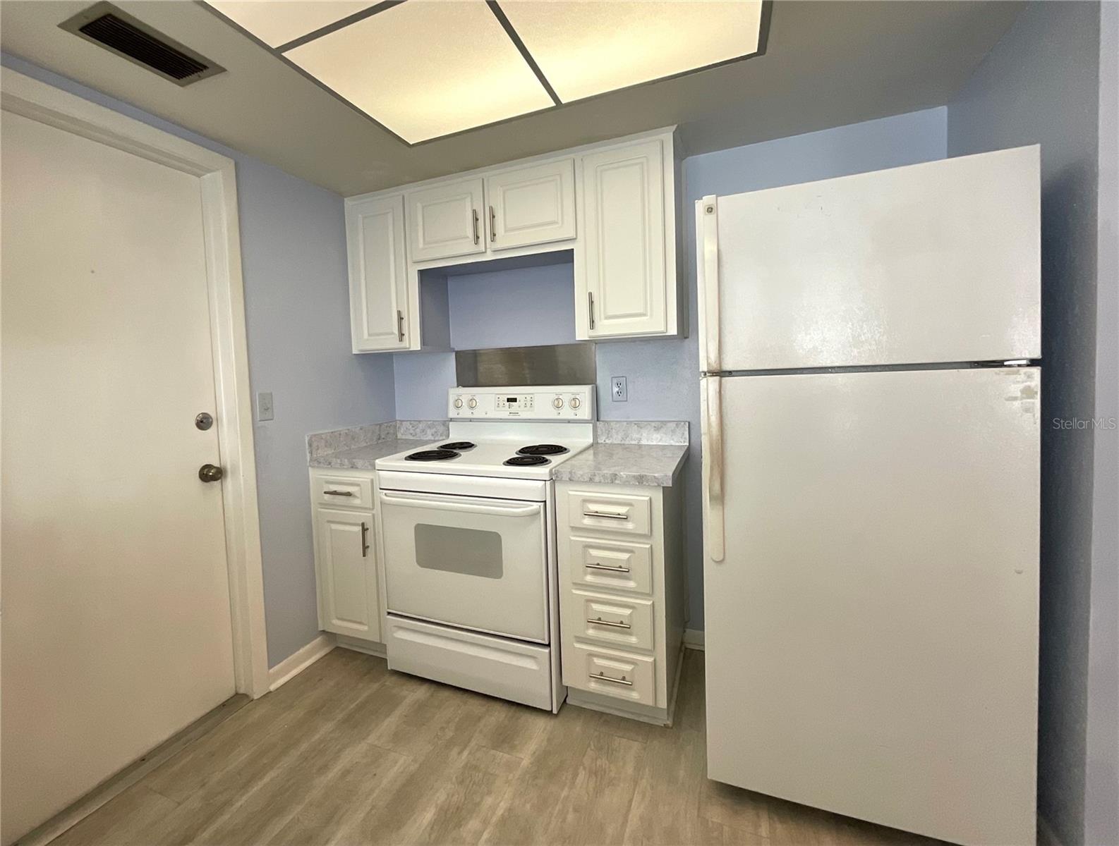 11-Kitchen view of range and refrigerator area