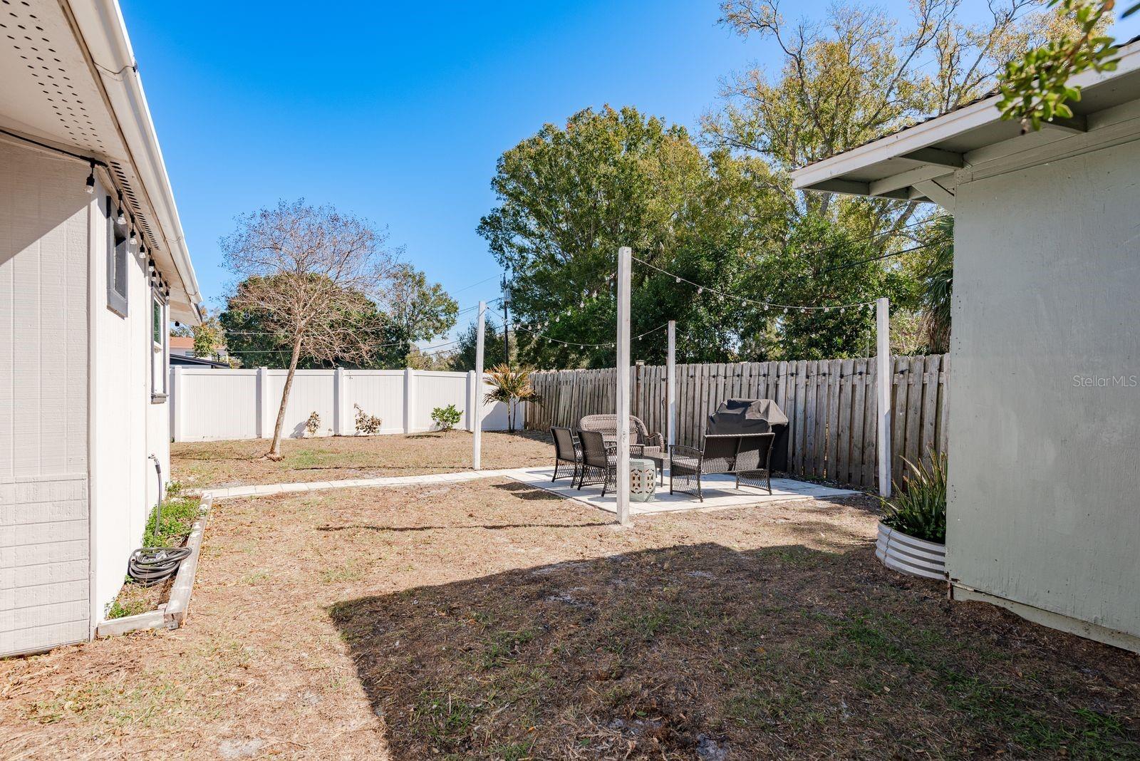 PVC and Wood Fencing Fully Surrounds the Backyard