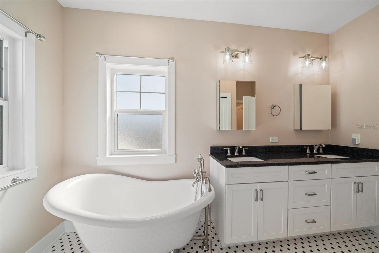 Master bath with separage claw foot tub and shower, double vanity