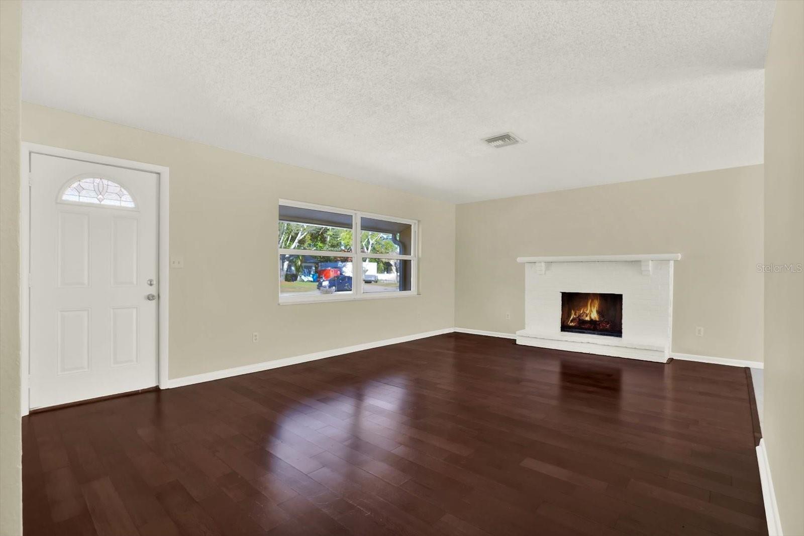 Living room has wood burning fireplace.