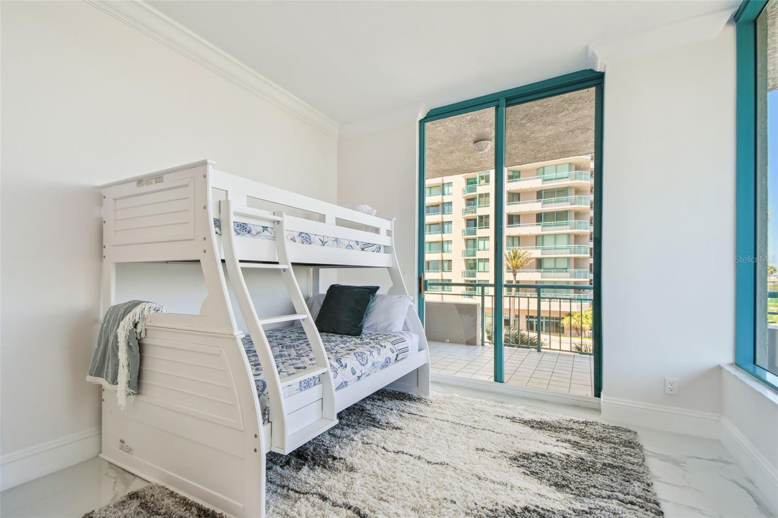 Bedroom 4 with balcony; views of city, pool & partial Gulf view