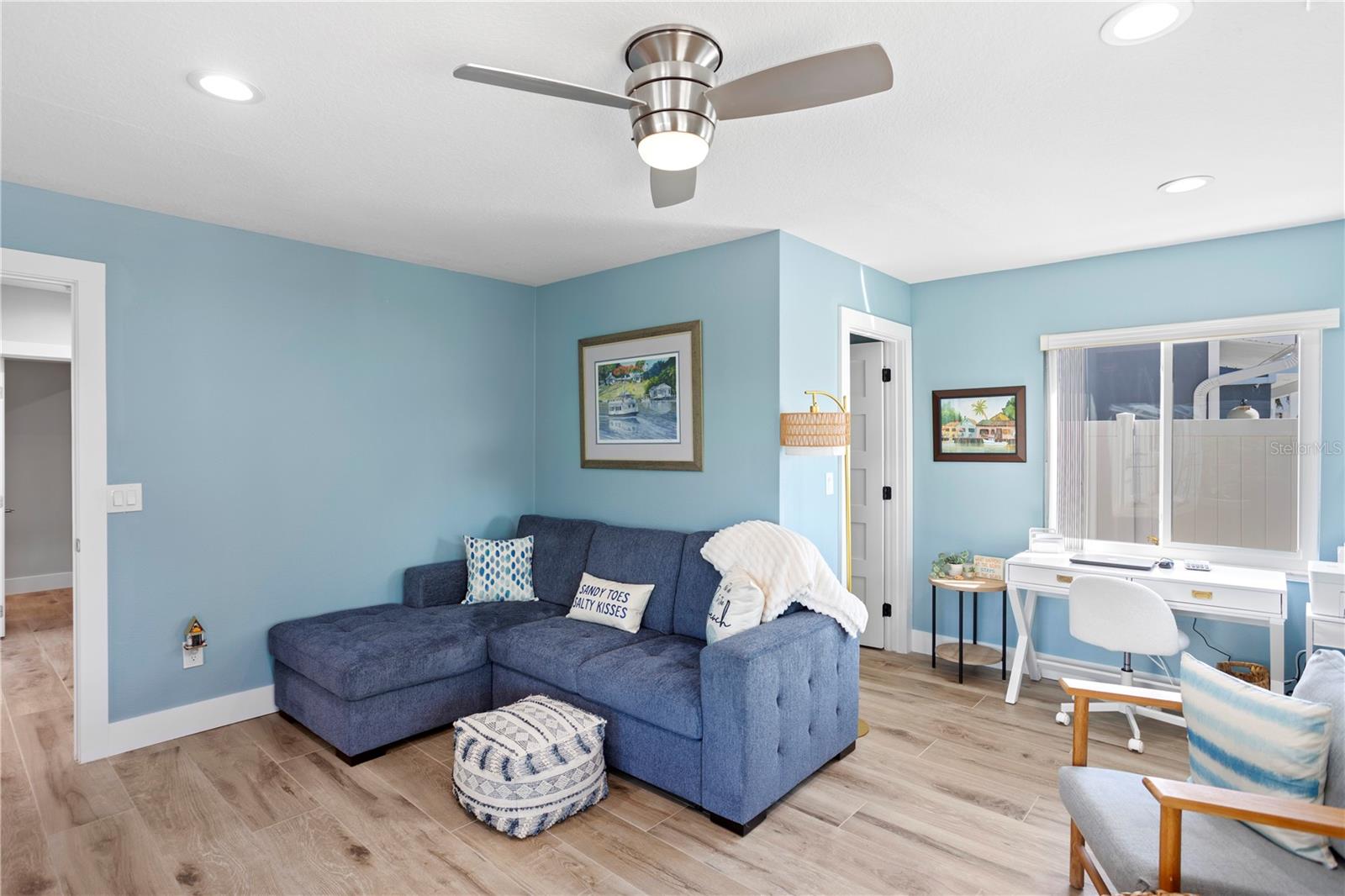 Guest bedroom with water view and patio access