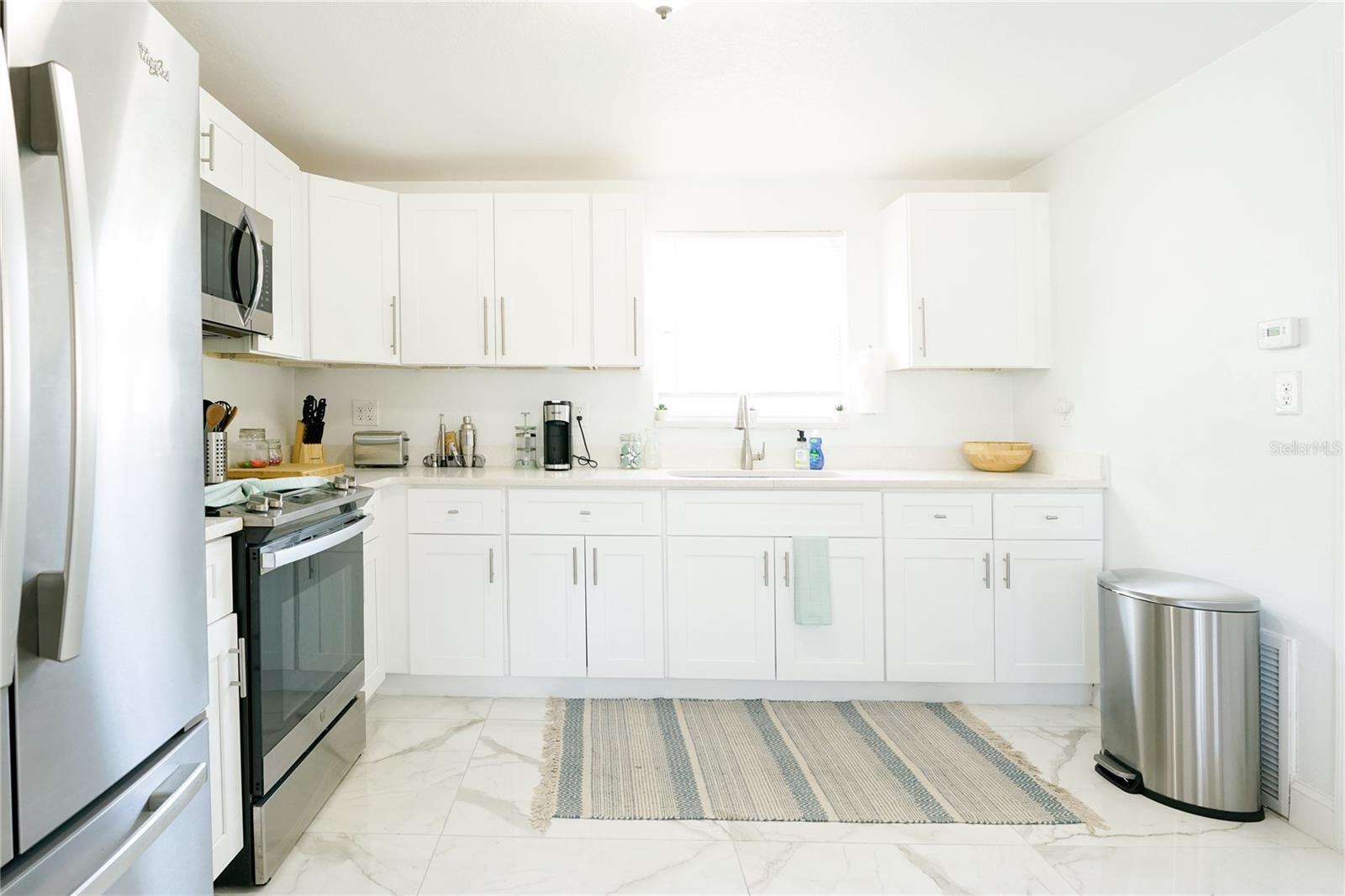 Well maintained kitchen featuring ample cabinetry, functional layout, and great prep space for everyday living or hosting.