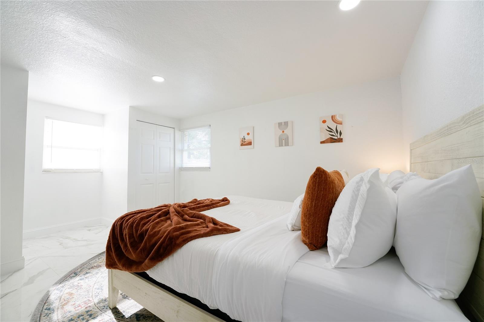 Spacious secondary bedroom featuring two closets for ample storage, making it ideal for guests, family members, or flexible use as a home office.