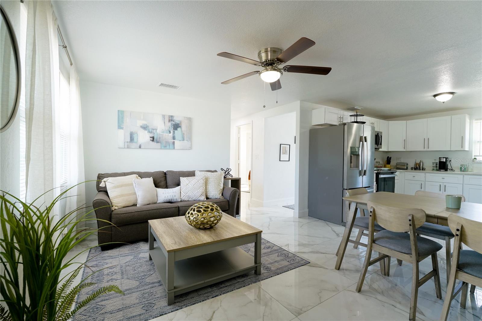 Spacious main living area with natural light and a comfortable flow into the dining and kitchen spaces.