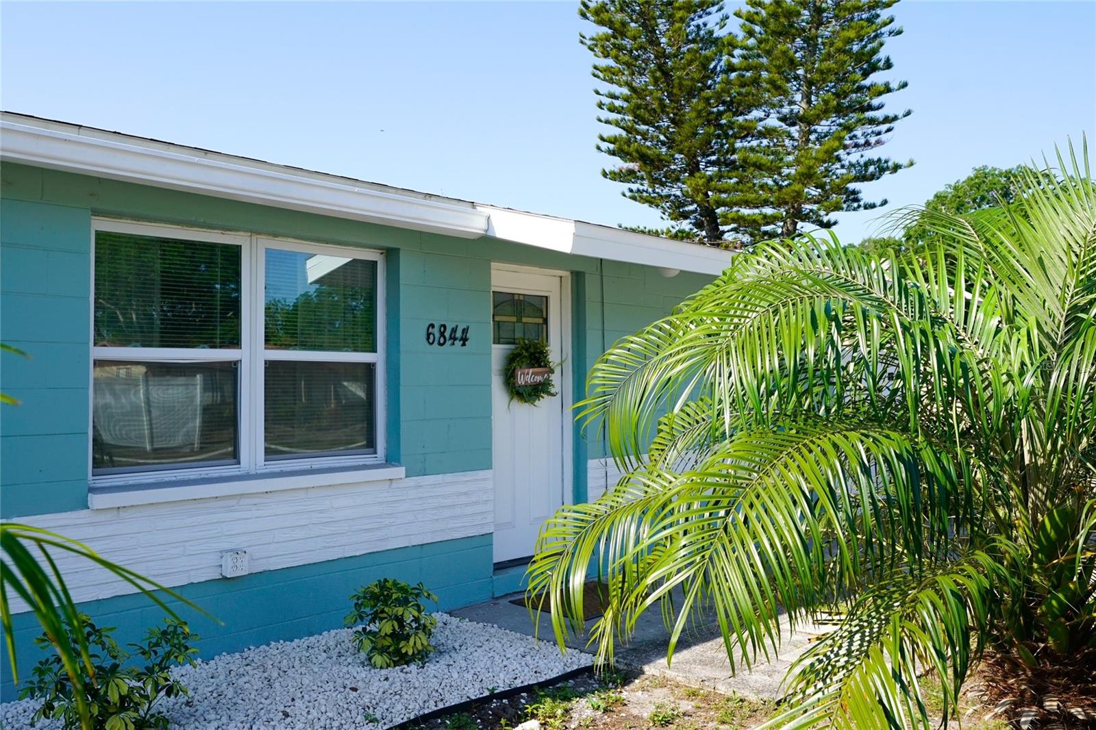 Newly installed lush landscaping enhances curb appeal and creates a fresh, welcoming first impression with vibrant greenery and clean, modern lines.