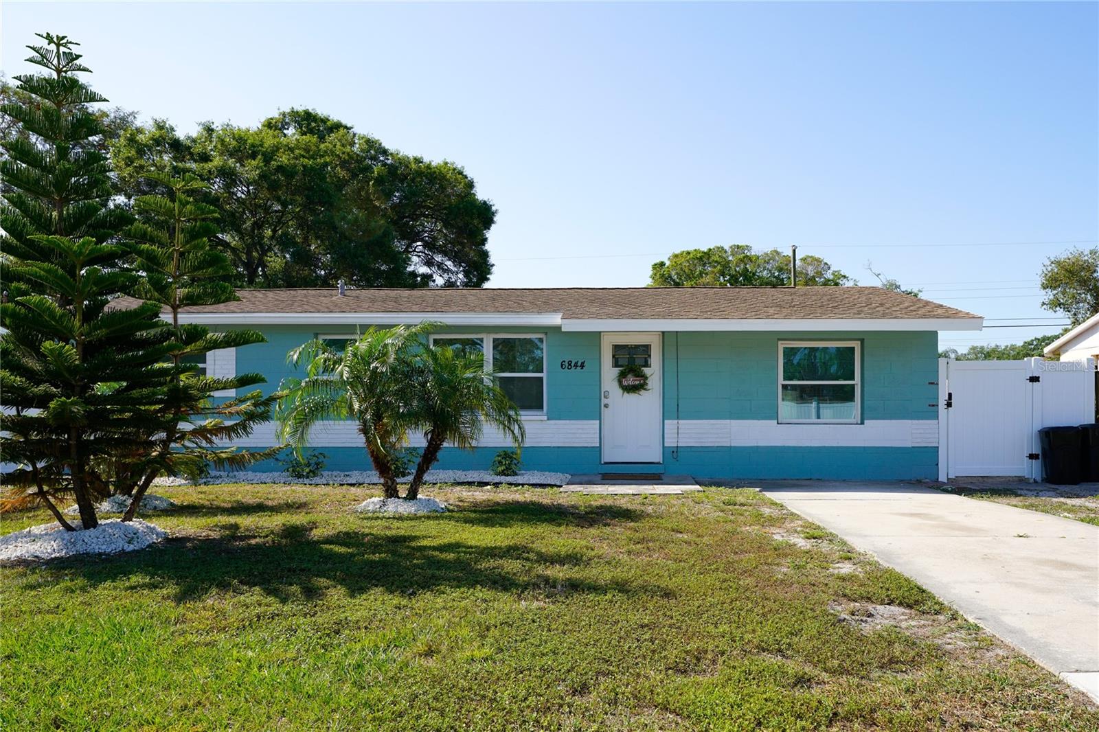 Charming curb appeal in a quiet, established Pinellas Park neighborhood with mature landscaping and welcoming entry.
