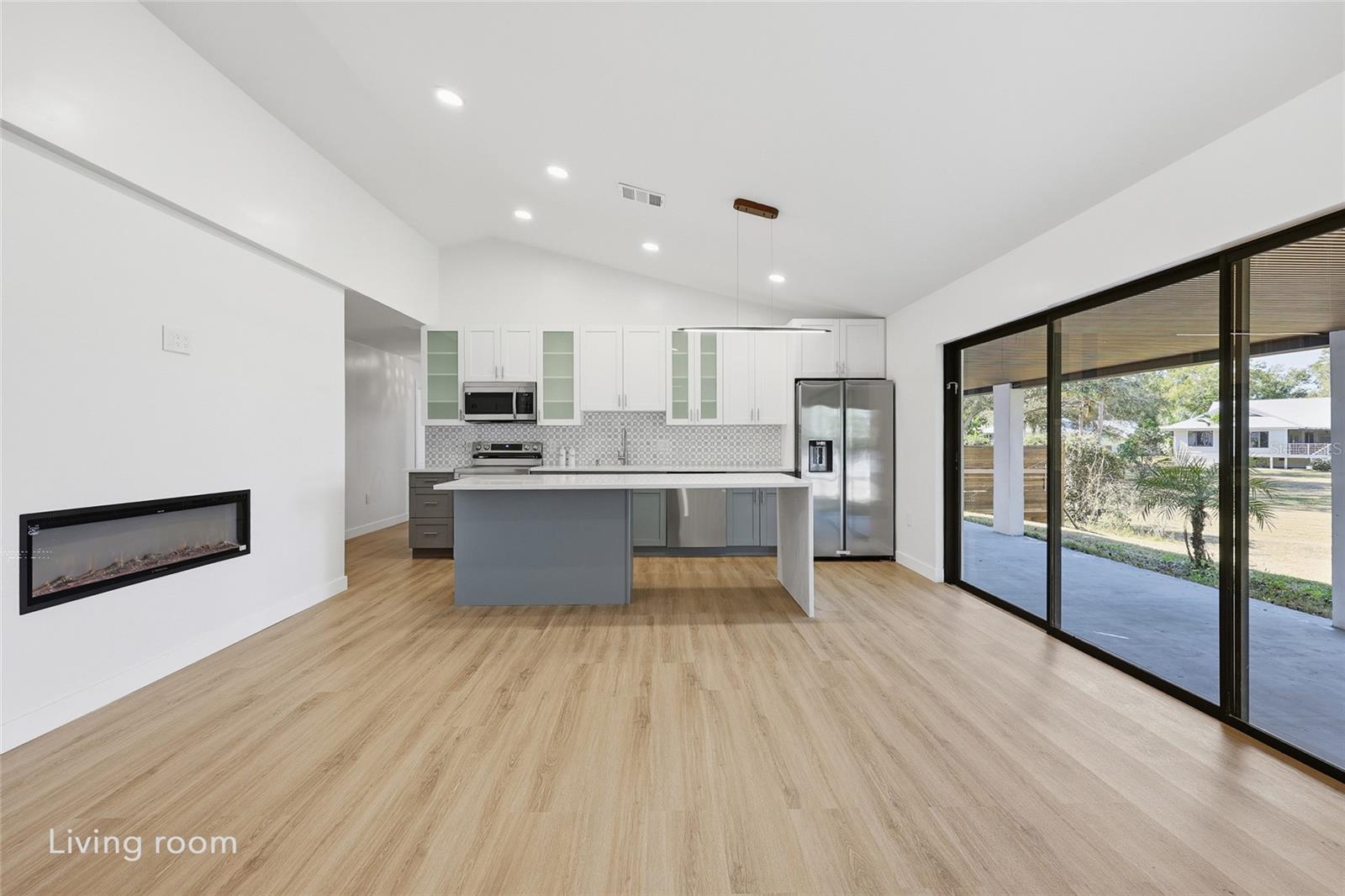 Open-concept kitchen with an electric fireplace