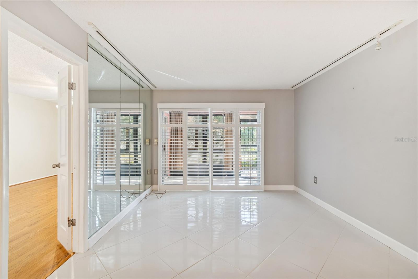 Living room leading to lanai and primary suite.